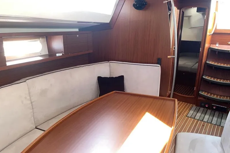 Slide: The Image of Interior of 2012 Delphia 47 yacht with wooden finish and cozy seating area. - 38