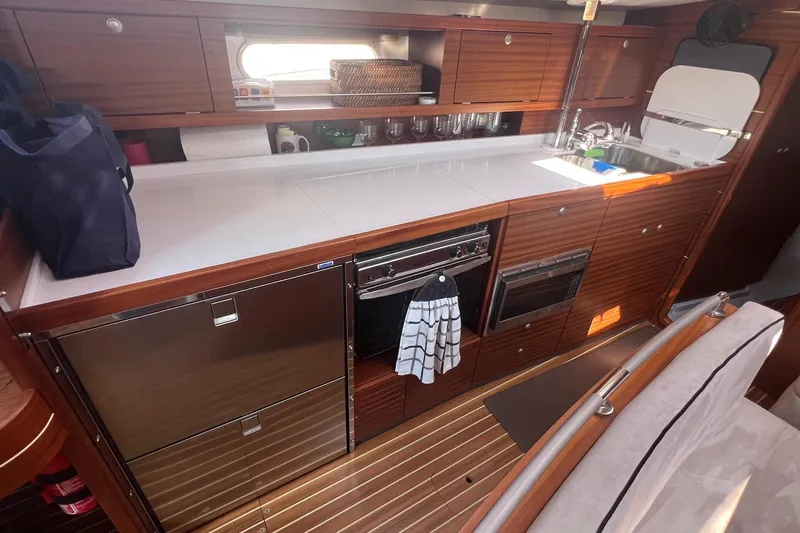 Slide: The Image of Interior of 2012 Delphia 47 yacht kitchen with wooden cabinetry and modern appliances. - 39