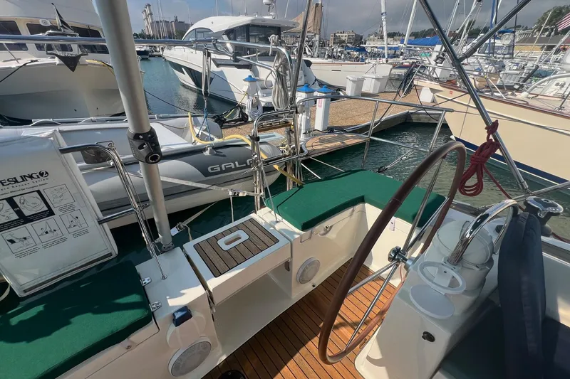 Slide: The Image of Cockpit of 2012 Delphia 47 yacht with wooden deck and steering wheel at marina. - 4