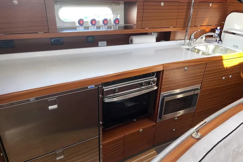 Slide: The Image of Modern kitchen in 2012 Delphia 47 yacht with wood cabinetry and stainless steel appliances. - 41