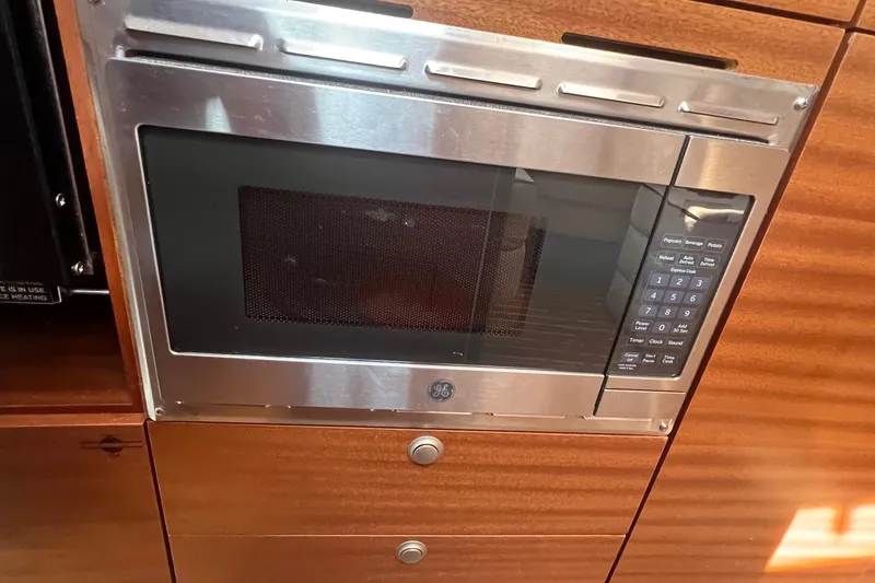 Slide: The Image of Built-in GE microwave in a Delphia 47 yacht, 2012 model, with wooden cabinetry. - 46