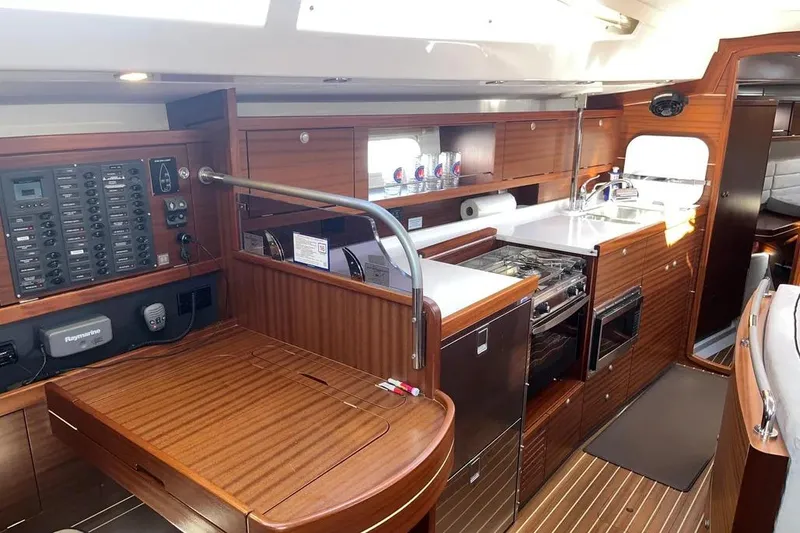 Slide: The Image of Interior of 2012 Delphia 47 yacht featuring a modern kitchen and control panel. - 47