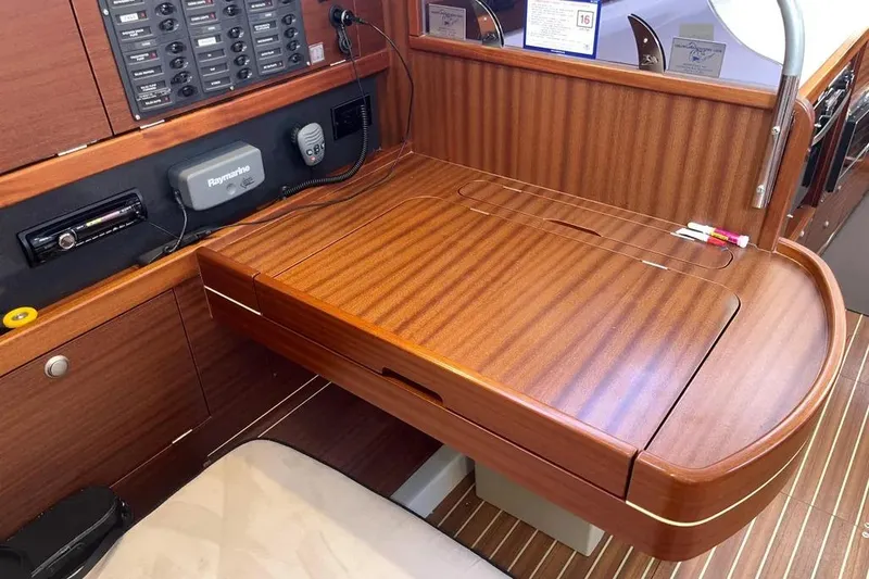 Slide: The Image of Interior of 2012 Delphia 47 yacht with wooden navigation desk and control panel. - 49