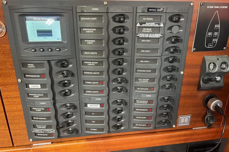 Slide: The Image of Control panel of a 2012 Delphia 47 yacht with various switches and indicators. - 53