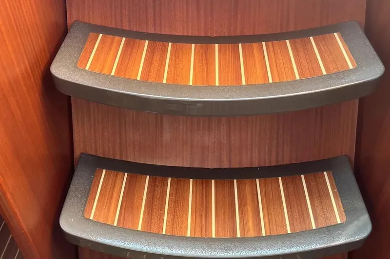 Slide: The Image of Wooden steps on a 2012 Delphia 47 yacht, featuring sleek design and craftsmanship. - 60