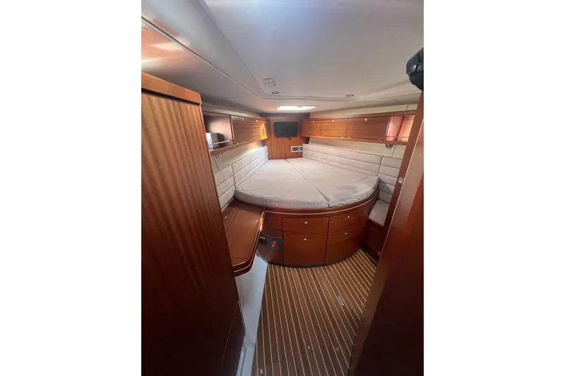 Slide: The Image of Luxurious cabin interior of 2012 Delphia 47 yacht with wood finish and cozy bed. - 61