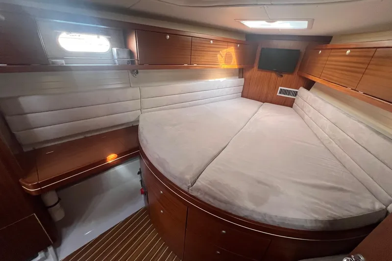 Slide: The Image of Luxurious cabin interior of 2012 Delphia 47 yacht with cozy bed and wooden finish. - 62