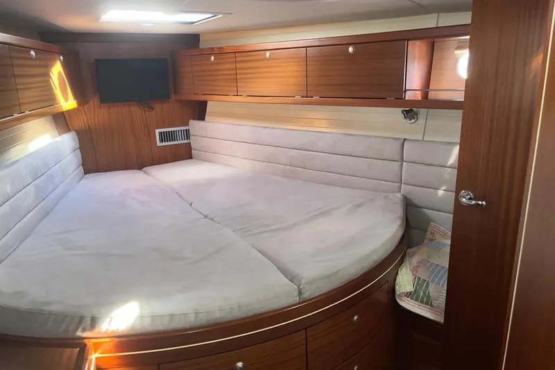 Slide: The Image of Luxurious cabin interior of 2012 Delphia 47 yacht with cozy bed and wooden finish. - 63