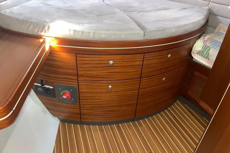 Slide: The Image of Interior of 2012 Delphia 47 yacht with wooden cabinetry and cushioned seating. - 64