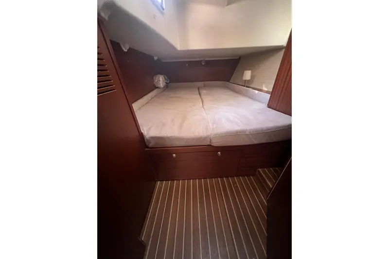 Slide: The Image of Cozy cabin interior of 2012 Delphia 47 yacht with wooden flooring and bed. - 67