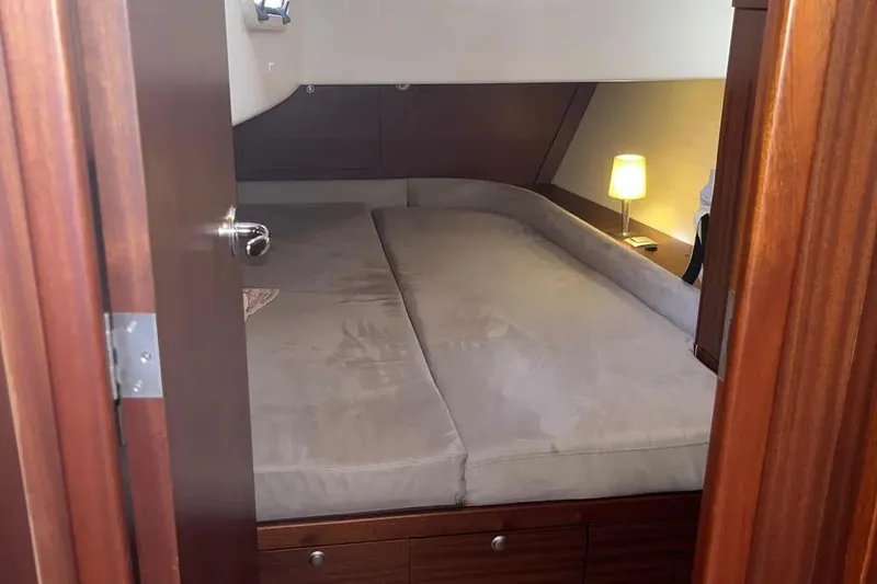 Slide: The Image of Cozy cabin interior of 2012 Delphia 47 yacht with bed and lamp. - 68