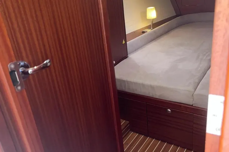 Slide: The Image of Cozy cabin interior of 2012 Delphia 47 yacht with wooden finish and soft lighting. - 70