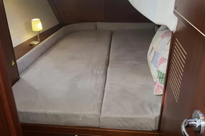 Slide: The Image of Cozy cabin interior of 2012 Delphia 47 yacht with bed and lamp. - 71