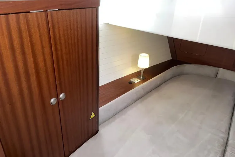 Slide: The Image of Cozy cabin interior of 2012 Delphia 47 yacht with wooden wardrobe and bedside lamp. - 73