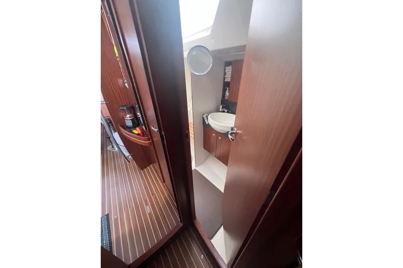 Slide: The Image of Interior of 2012 Delphia 47 yacht showing bathroom and wooden flooring. - 79