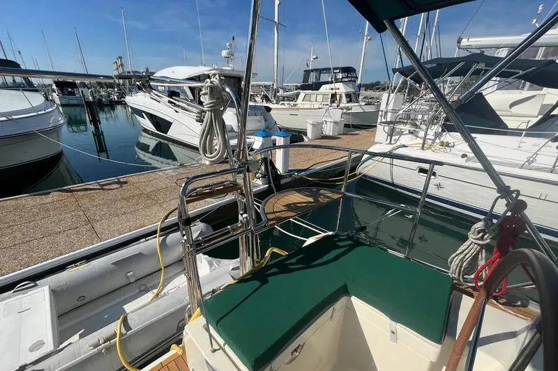 Slide: The Image of Delphia 47 yacht from 2012 docked at a marina, surrounded by other boats. - 8