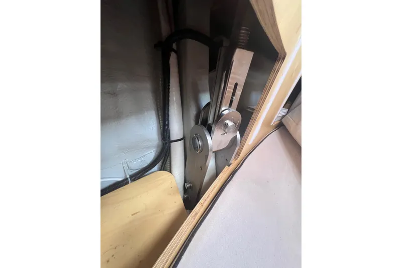 Slide: The Image of Interior mechanism of a 2012 Delphia 47 yacht, showcasing metal components and wooden paneling. - 82