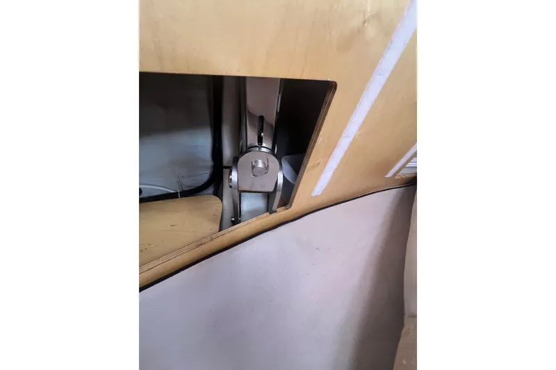 Slide: The Image of Interior view of a 2012 Delphia 47 yacht, showcasing wooden paneling and metal fittings. - 83