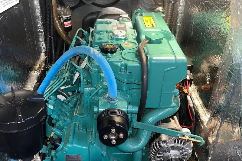 Slide: The Image of Engine compartment of a 2012 Delphia 47 yacht, featuring a green marine engine. - 84