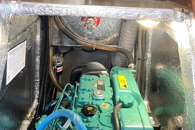 Slide: The Image of Engine compartment of a 2012 Delphia 47 yacht, featuring a well-maintained marine engine. - 85