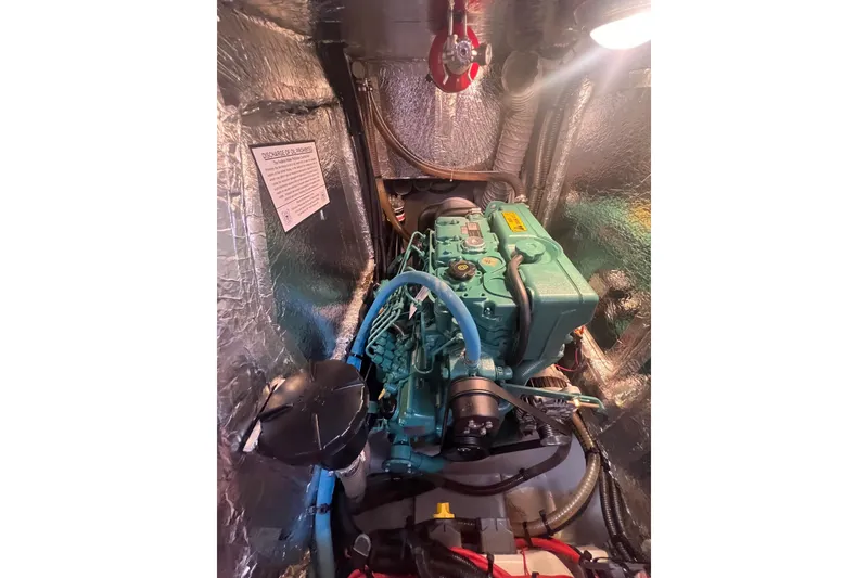 Slide: The Image of Engine compartment of a 2012 Delphia 47 yacht, featuring a well-maintained marine engine. - 86