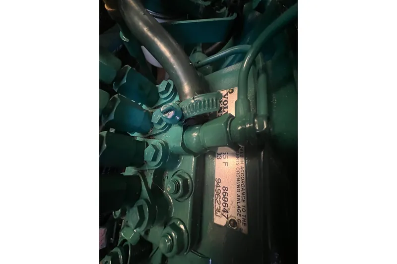 Slide: The Image of Close-up of a 2012 Delphia 47 engine component with visible serial numbers. - 87