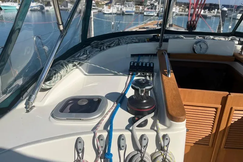 Slide: The Image of Cockpit of 2012 Delphia 47 yacht with ropes and winch, docked at marina. - 9