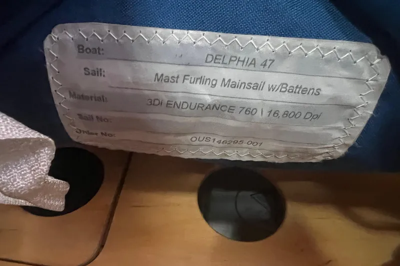 Slide: The Image of Label on Delphia 47 sail, 2012 model, featuring mast furling mainsail with battens. - 90