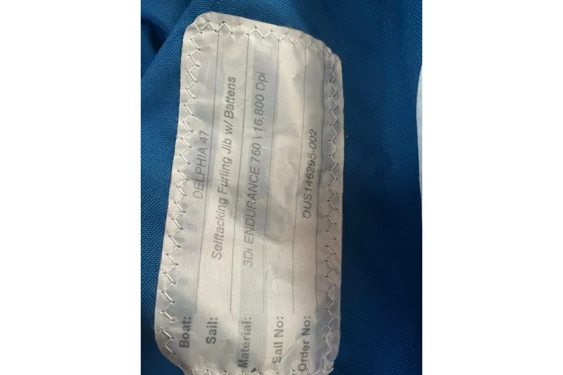 Slide: The Image of Label on blue fabric for Delphia 47 sailboat, 2012 model, self-tacking jib details. - 91