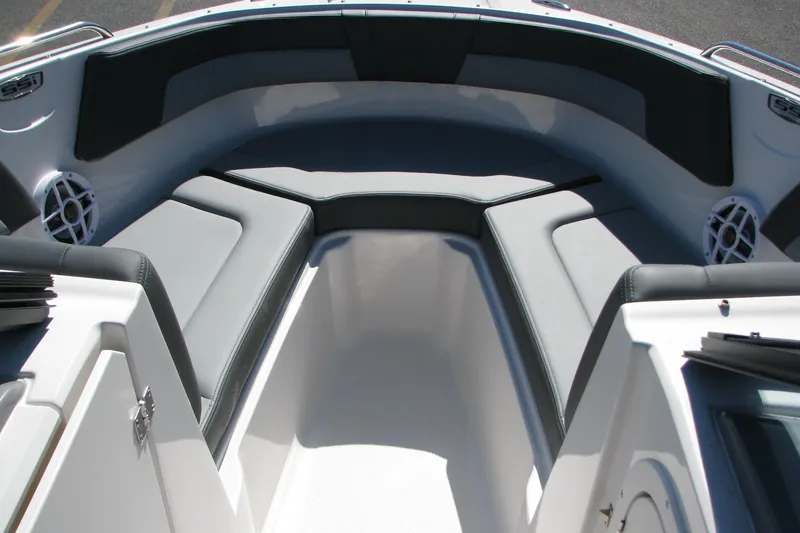 Slide: The Image of 2026 Chaparral 23 SSi OB boat interior with cushioned seating and speakers. - 7