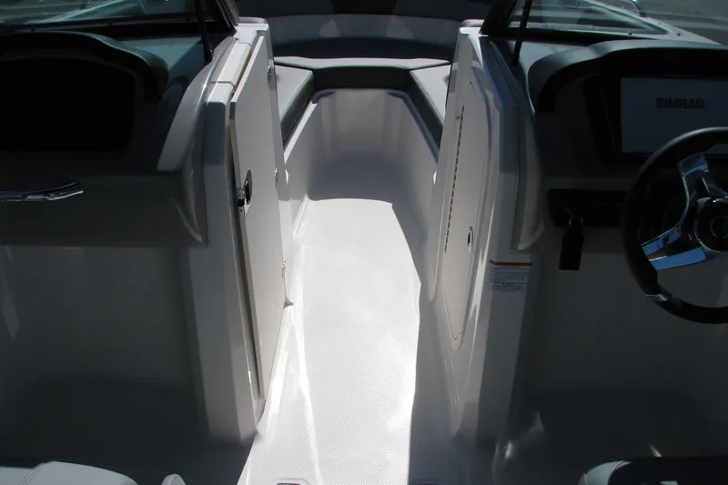 Slide: The Image of 2026 Chaparral 23 SSi OB boat interior with steering wheel and seating area. - 8
