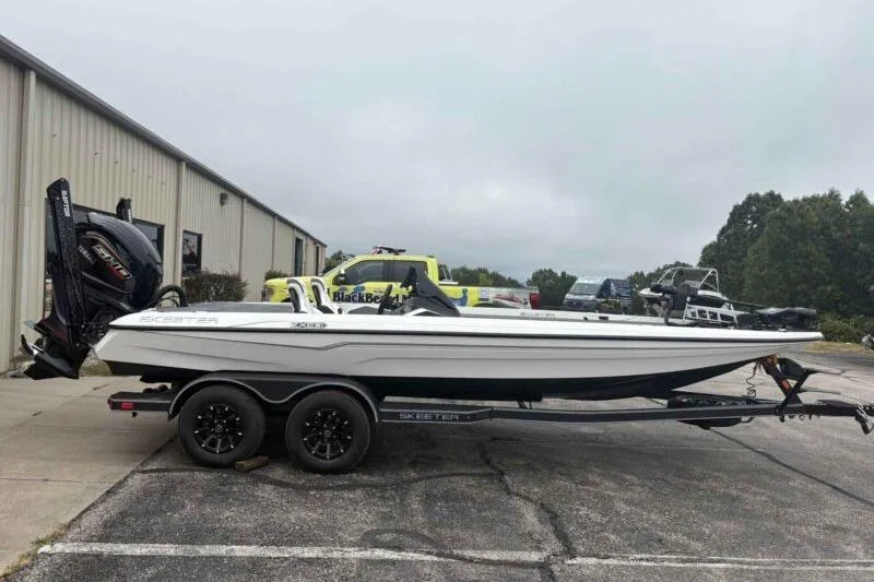 The Image of 2026 Skeeter ZXE21 boat on trailer, parked outdoors near a building. - 0