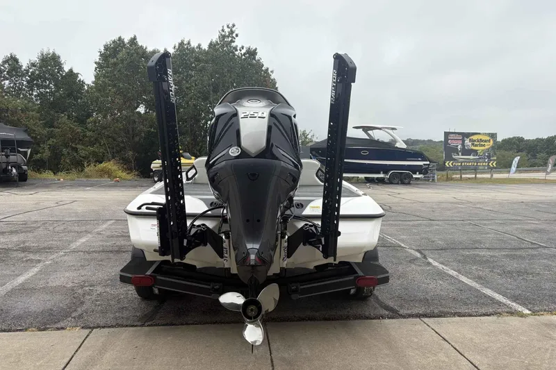 Slide: The Image of 2026 Skeeter ZXE21 boat with powerful outboard motor, parked outdoors. - 5