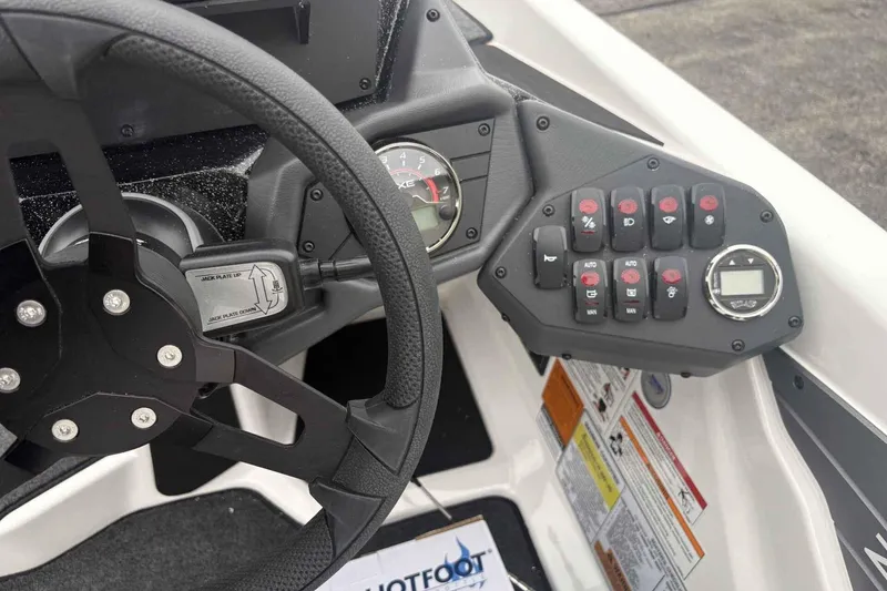 Slide: The Image of Steering wheel and control panel of 2026 Skeeter ZXE21 boat, featuring various switches and gauges. - 7