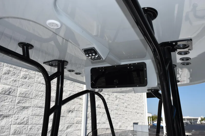 Slide: The Image of 2026 BlackJack 256 Coastal boat T-top with rod holders and control panel. - 10