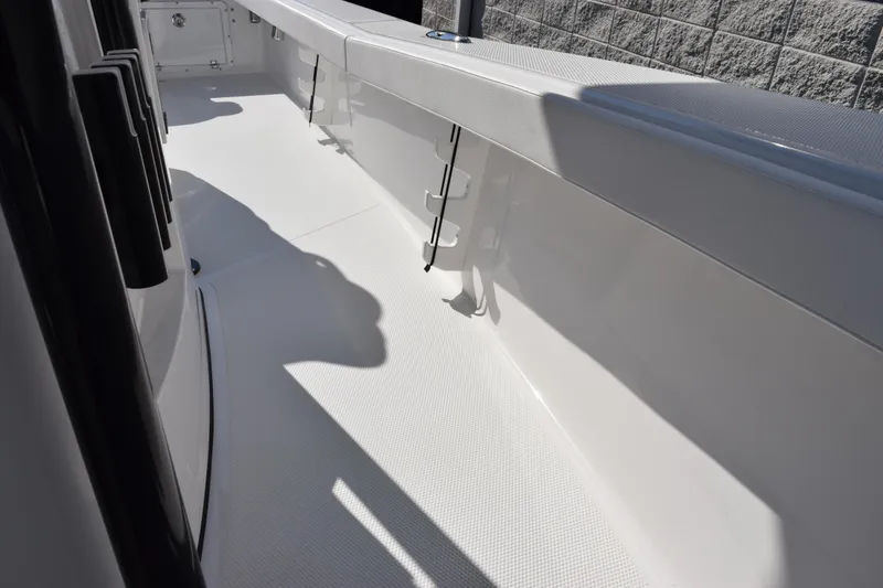 Slide: The Image of 2026 BlackJack 256 Coastal boat interior with sleek white deck and side railings. - 14