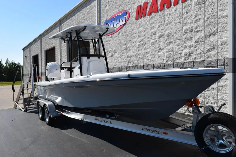 Slide: The Image of 2026 BlackJack 256 Coastal boat on trailer outside marine store. - 2