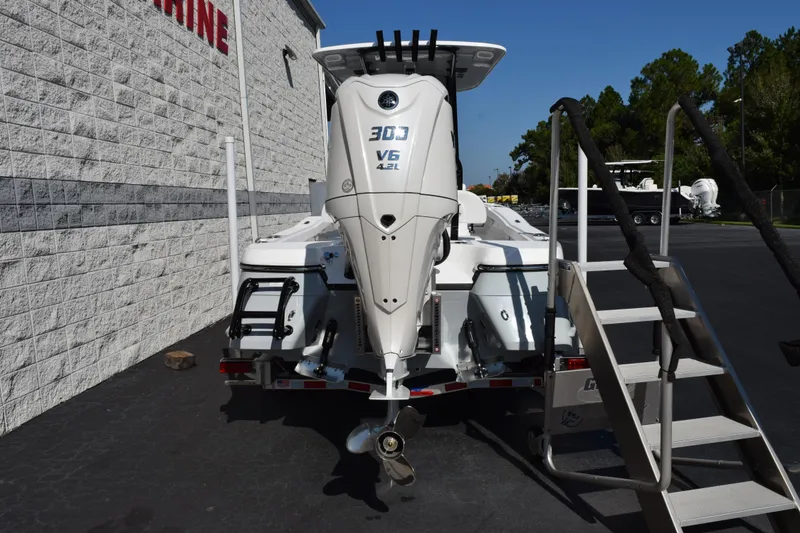 Slide: The Image of 2026 BlackJack 256 Coastal boat with powerful V6 engine, parked near a building. - 5