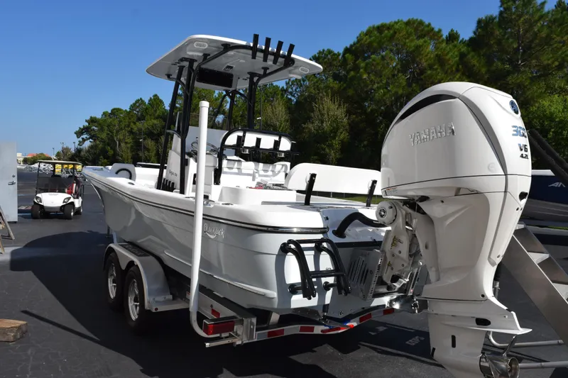 Slide: The Image of 2026 BlackJack 256 Coastal boat with Yamaha engine on trailer, parked outdoors. - 6
