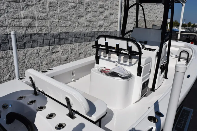 Slide: The Image of 2026 BlackJack 256 Coastal boat interior with fishing rod holders and seating. - 7