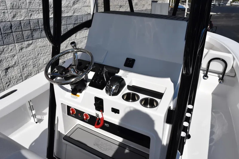 Slide: The Image of 2026 BlackJack 256 Coastal boat console with steering wheel, controls, and cup holders. - 9