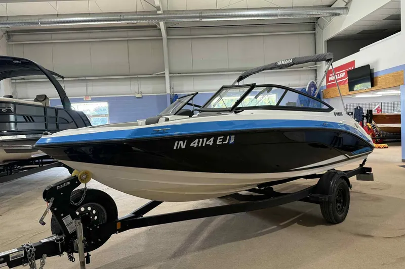 The Image of 2022 Yamaha SX190 boat on trailer in showroom, side view. - 0