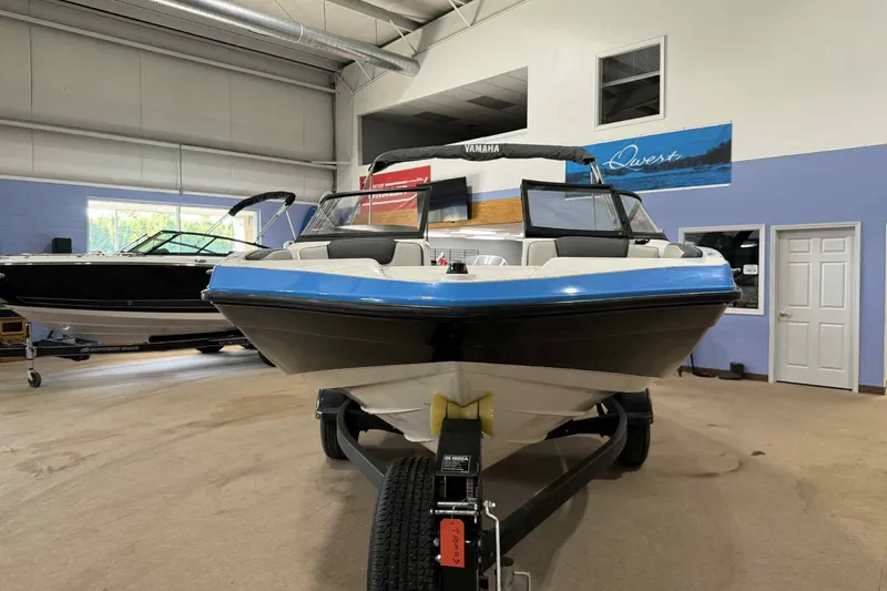 Slide: The Image of 2022 Yamaha Boats SX190 displayed indoors on a trailer. - 1