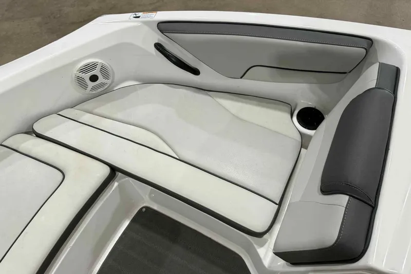Slide: The Image of 2022 Yamaha Boats SX190 interior seating with speaker and cup holder. - 10