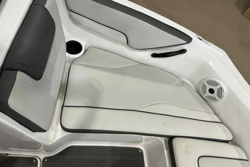 Slide: The Image of 2022 Yamaha SX190 boat interior with cushioned seating and speaker. - 11
