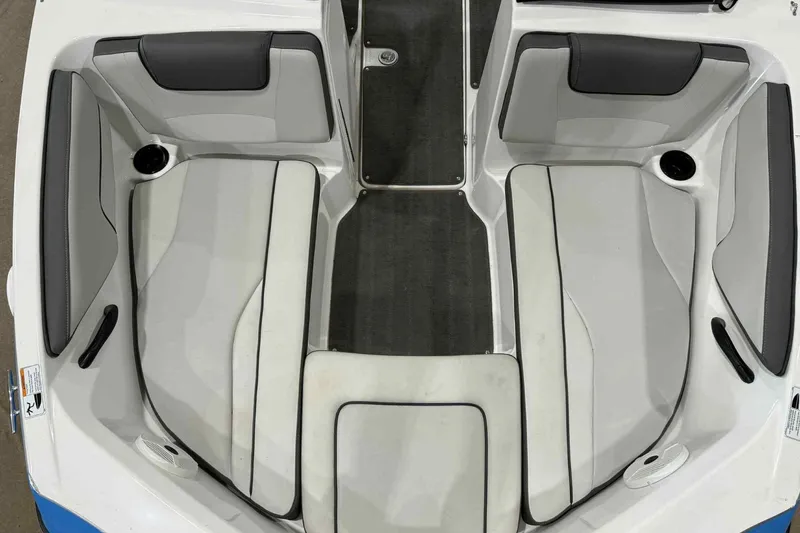 Slide: The Image of 2022 Yamaha Boats SX190 interior seating with gray and white upholstery. - 12