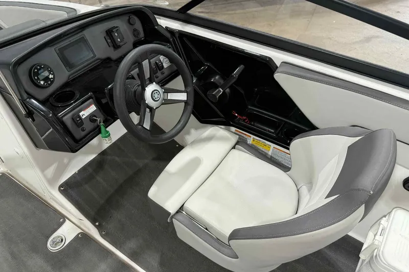 Slide: The Image of 2022 Yamaha Boats SX190 cockpit with steering wheel, dashboard, and captain's seat. - 16