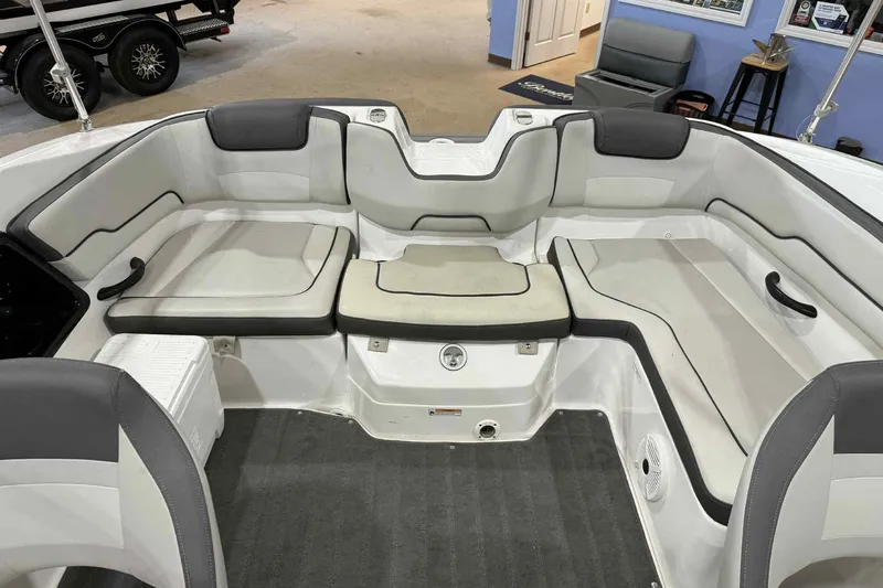 Slide: The Image of 2022 Yamaha Boats SX190 interior seating with gray and white upholstery. - 21