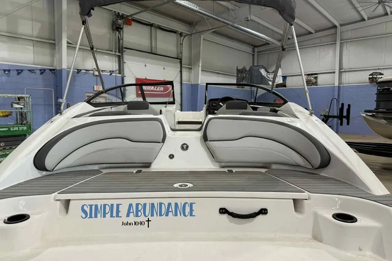 Slide: The Image of 2022 Yamaha Boats SX190 in showroom, featuring "Simple Abundance" text on the stern. - 5