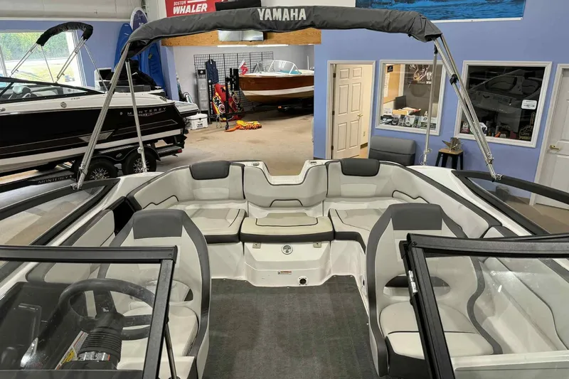 Slide: The Image of 2022 Yamaha Boats SX190 interior with seating and steering wheel in showroom. - 8